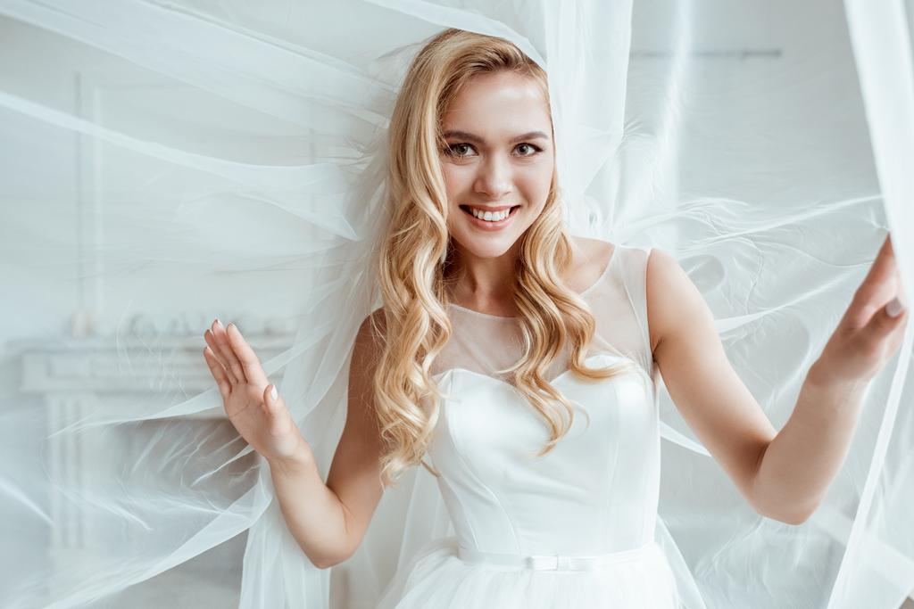 Beautiful young bride in wedding dress with bridal veil