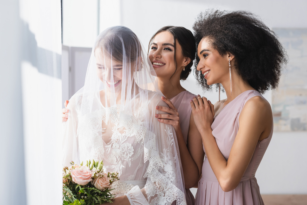 Happy bride holding wedding bouquet